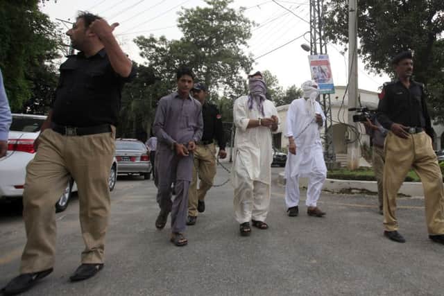 Pakistani police officers escort father Muhammad Shahid, second right, and ex-husband Muhammad Shakeel, third right, of slain British-Pakistani woman Samia Shahid to court