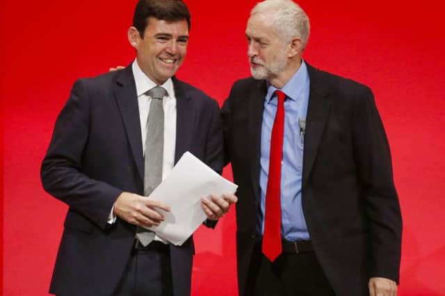 Labour leader Jeremy Corbyn congratulates Shadow Home Secretary Andy Burnham after he delivered his speech on the final day of the Labour Party conference in Liverpool.