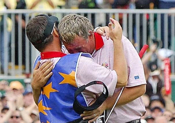 Europe's Darren Clarke hugs his caddy after defeating USA's Zach Johnson on the final day of the Ryder Cup, at the K Club in September 2006. Picture: Rui Vieira/PA