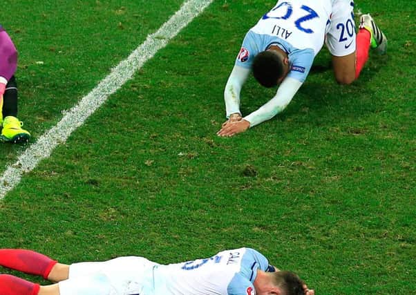 England playes lie on the pitch after being beaten by Iceland at this years Euros.  (PA).
