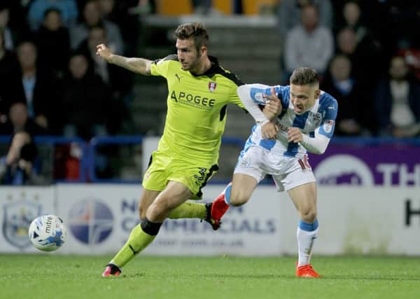 Rotherham United's Joe Mattock holds off Huddersfield Town's Jack Payne (right) during the Yorkshire derby at the John Smith's Stadium. Picture: Richard Sellers/PA.