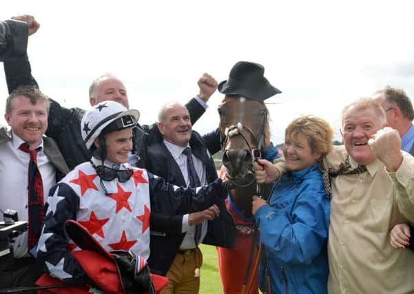 Heartbreak City has a hat put on his head as jockey Adam McNamara and connections celebrate winning the Betfred Ebor at York last month. Picture: Anna Gowthorpe/PA