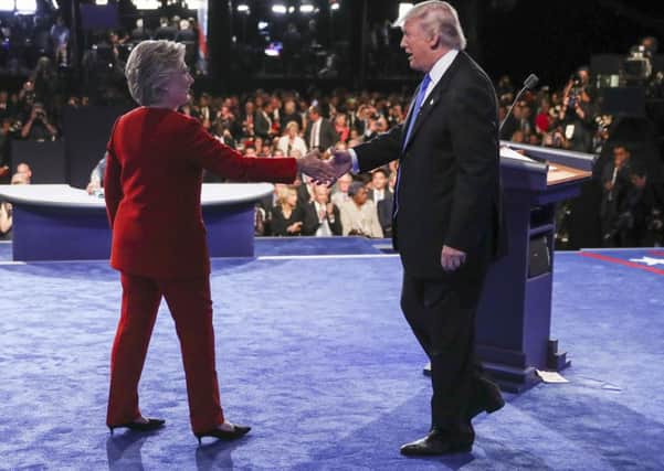 Hillary Clinton shakes hands with Donald Trump after their first debate.