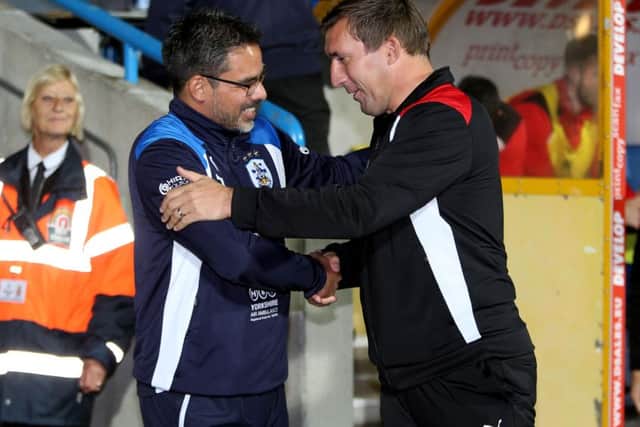 Huddersfield Town manager David Wagner (left) and Rotherham United manager Alan Stubbs shake hands before Tuesday night's derby. Picture: Richard Sellers/PA.