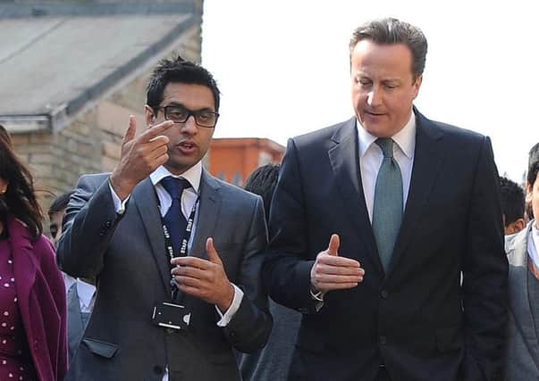 Then Prime Minister David Cameron meeting headteacher Sajid Hussain Raza at Kings Science Academy, Bradford