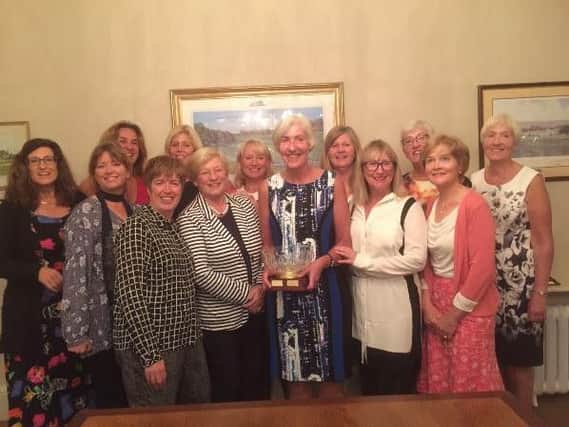 Moortown's Leeds Evening League captain Susan Mannion receives the trophy during a presentation dinner held at the club.