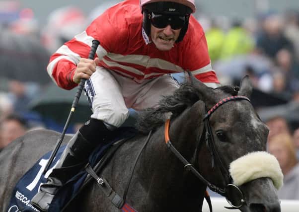 Jockey Paul Mulrennan celebrates as he rides Mecca's Angel to victory in the Coolmore Nunthorpe Stakes.