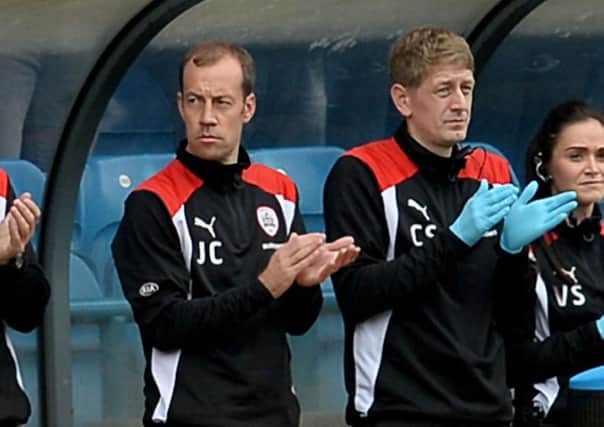 Coach Jamie Clapham, left, takes his place in the Barnsley dugout at Elland Road (Picture: James Hardisty).