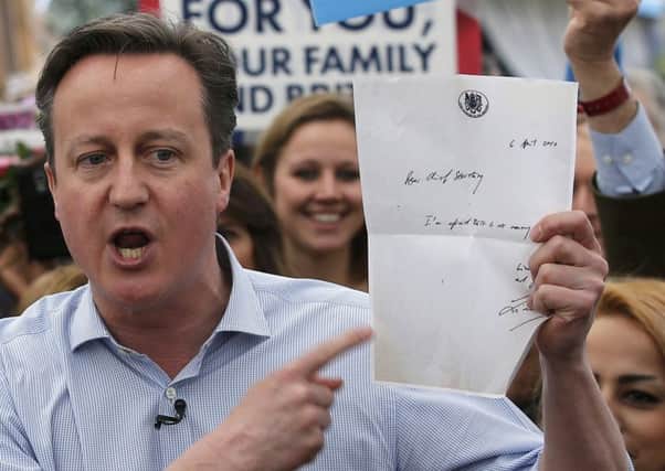 David Cameron holding a copy of the infamous note written by an outgoing Labour minister to his successor admitting there was ''no money'' left, as a bureaucratic custody battle is being fought over possession of the letter.  PIC: PA