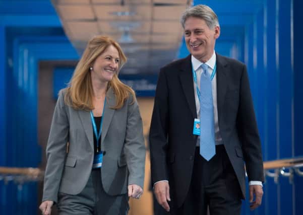 Chancellor of the Exchequer Philip Hammond and his wife Susan Williams-Walker walk to the International Conference Centre as they arrive at the Conservative party conference in Birmingham. PIC: PA