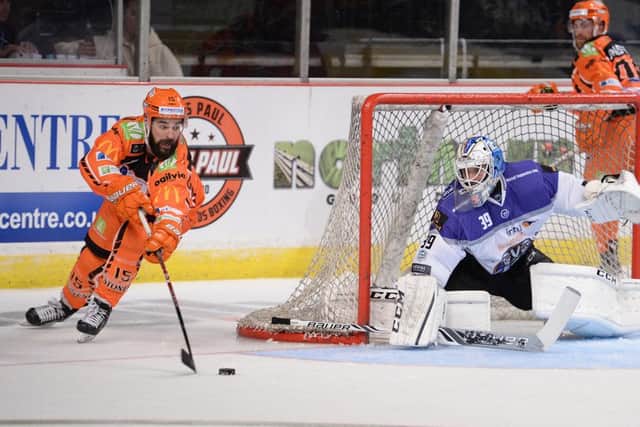 Sheffield Steelers' Mathieu Roy rounds the goal before firing a shot in against Braehead Clan's Michal Zajkowski. Picture: Dean Woolley