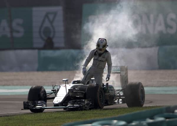 Mercedes driver Lewis Hamilton of Britain leaves his car after an engine failure during the Malaysian Grand Prix. Picture: AP/Brian Ching