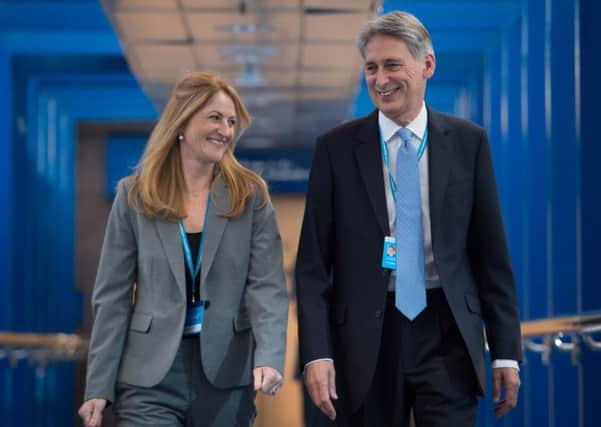 Chancellor of the Exchequer Philip Hammond and his wife Susan Williams-Walker walk to the International Conference Centre as they arrive at the Conservative party conference in Birmingham. Stefan Rousseau/PA Wire