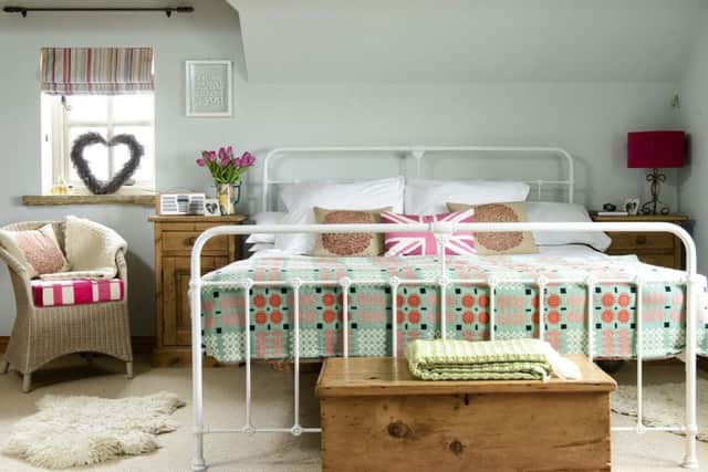 A Queen size bed from M&amp;S, covered with a pretty Welsh throw that belonged to an

aunt, are off-set by the Laura Ashley Eau de Nil wall colour.