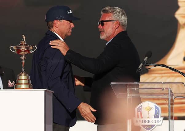 USA captain Davis Love III embraces his European counterpart Darren Clarke  during the closing ceremony of the Ryder Cup at Hazeltine (Picture: Peter Byrne/PA Wire).
