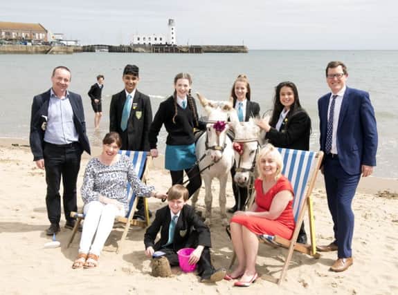 Matt Parsons from Sirius Minerals (back left); with Scalby school pupils left to right  Joe Huntley, Abdul Hameed Firfirey, Eleanor Davidson, Rowan Hawes (with bucket), Margherita Puccinelli and Ruby Hilton; North Yorkshire County Council prevention.
(front left), Vicki Logan headteacher of Overdale Primary School (front right) and

Paul Offord, Scarboroughs lead practitioner for English (far right).