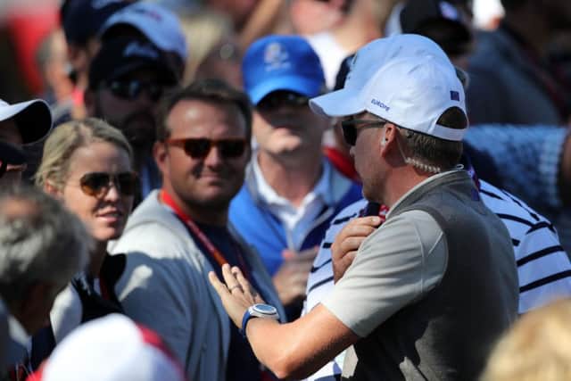 Europe vice captain Ian Poulter speaks with a fans after they heckled Danny Willett.