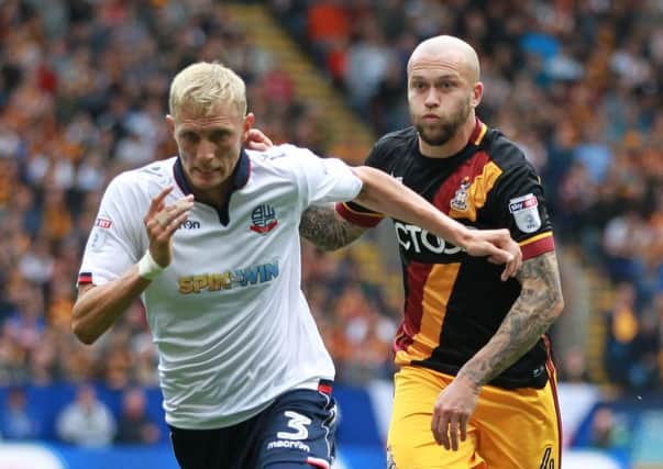 Bolton Wanderers Dean Moxey gets away from Bradford City's Nicky Law.