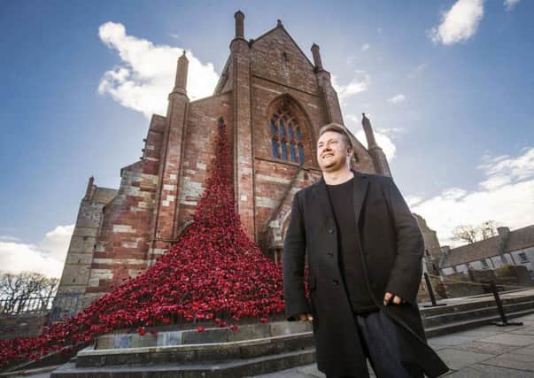 Artist Paul Cummins with his Weeping Window sculpture made of ceramic poppies at St Magnus Cathedral in Orkney, Scotland, earlier this year. The sea of ceramic poppies, first seen at the Tower of London, is coming to Hull next year.