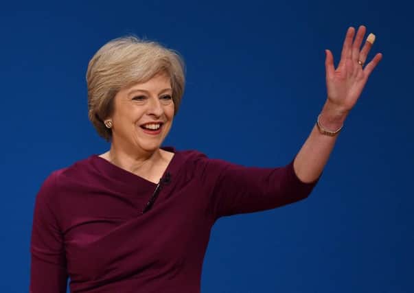 Theresa May greets her audience at the Tory Party conference today.