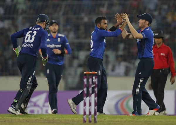 England's Adil Rashid, second right, celebrates with his teammates after the dismissal of Bangladesh's Mahmudullah.
