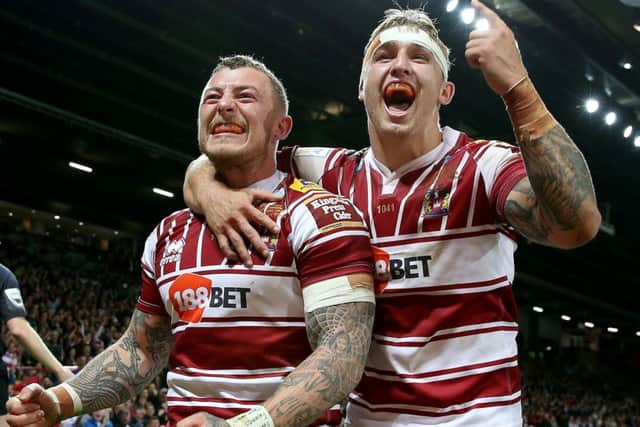 Wigan Warriors Josh Charnley (left) celebrates his try against Warrington Wolves with Sam Powell. Picture: Martin Rickett/PA.