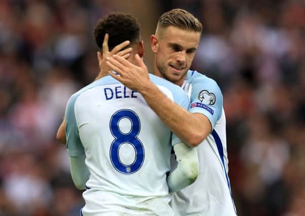 England's Dele Alli celebrates scoring his side's second goal of the game wit team mate Jordan Henderson during the 2018 FIFA World Cup Qualifying match at Wembley Stadium, London.