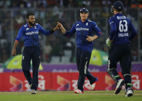 England and Yorkshire's Adil Rashid, left, celebrates with team-mates after the dismissal of Bangladesh's Mosaddek Hossain in Dhaka, Bangladesh, Sunday, Oct. 9, 2016.AP/A.M. Ahad