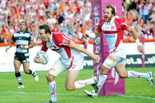 Hull KR's Paul Cooke goes over to score a try against former club, Hull FC, in July 2009. Picture: Anna Gowthorpe/PA