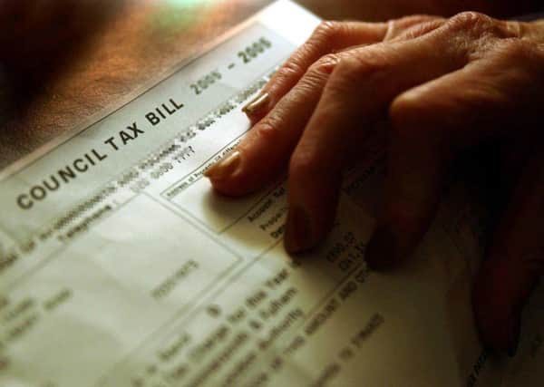 A pensioner examines her council tax bill