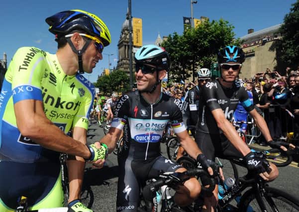 Mark Cavendish (centre) shakes hands with Alberto Contador (left) and Chris Froome at the start of of the first stage of the Tour de France in in Leeds. Picture: Bruce Rollinson