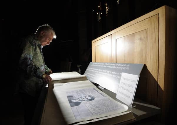 Moving: Ben Mole looks at the commemoration book at Wakefield Cathedral.   
Picture by Simon Hulme