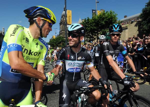 Mark Cavendish (centre) shakes hands with Alberto Contador (left) and Chris Froome at the start of of the first stage of the Tour de France in in Leeds. Picture: Bruce Rollinson