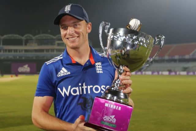 England's captain Jos Buttler poses for with the winner's trophy for their ODI series against Bangladesh. Picture: AP/AM Ahad.