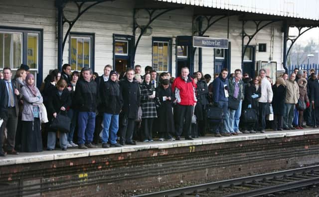 Commuters waiting on a platform