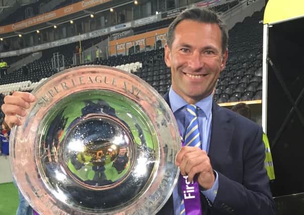 SHIELD SUCCESS: Roger Draper with the League Leaders Shield won by Warrington Wolves, where he has been the clubs chief executive. Picture: RFL