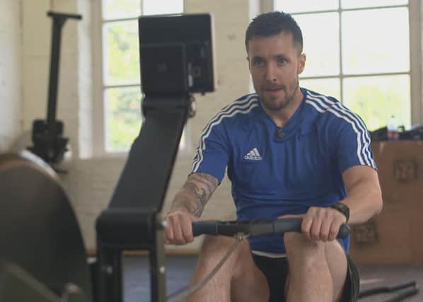 Keeping fit: Michael Collins gets on the rowing machine as he waits for the call from a Football League club. (Picture: Simon Watts)