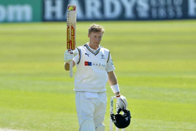 HELPING HAND: Joe Root celebrates his century.  Picture: Bruce Rollinson