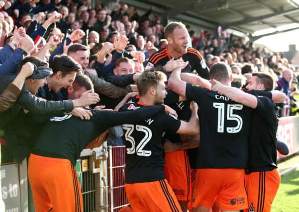 Ethan Ebanks-Landell of Sheffield United is mobbed as he celebrates the equalising goal at Fleetwood.