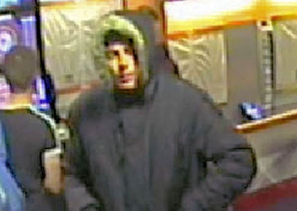 A CCTV still showing the suspect.