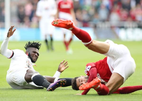 ROLL OVER< ROLL OVER: Watford's Isaac Success (left) battles for the ball with Middlesbrough's Antonio Barragan (right) Picture: Owen Humphreys/PA