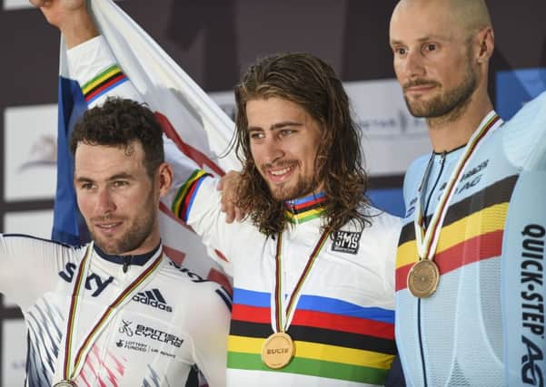 Gold medalist Peter Sagan of Slovakia, center, celebrates on the podium with second place Mark Cavendish of Great Britain, left and third place Tom Boonen of Belgium, after the men's Elite Road Race at the 2016 Road World Championships in Doha. Picture: AP/Alexandra Panagiotidou)