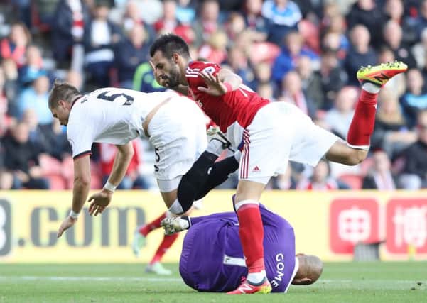 Watford goalkeeper Heurelho Gomes saves at the feet of Middlesbrough's Alvaro Negredo. Picture: Owen Humphreys/PA