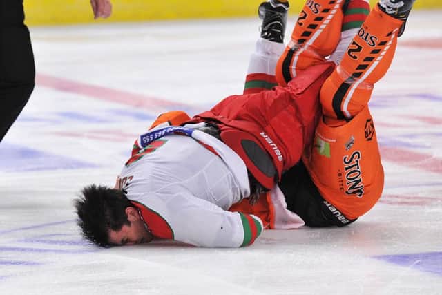 GOTTA HURT: Cardiff's Mark Louis crashes face-first into the ice after his fight with Sheffield Steelers' Zack Fitzgerald. Picture: Dean Woolley.