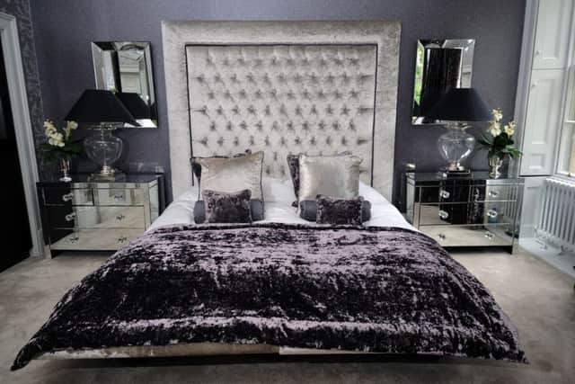 The opulent master bedroom suite with supersize headboard