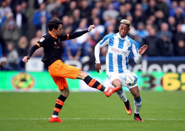 HEAD TO HEAD: Sheffield Wednesday's Kieran Lee and Huddersfield Town's Rajiv van La Parra battle for the ball during Sunday's Championship encounter at the John Smith's Stadium. Picture: Danny Lawson/PA