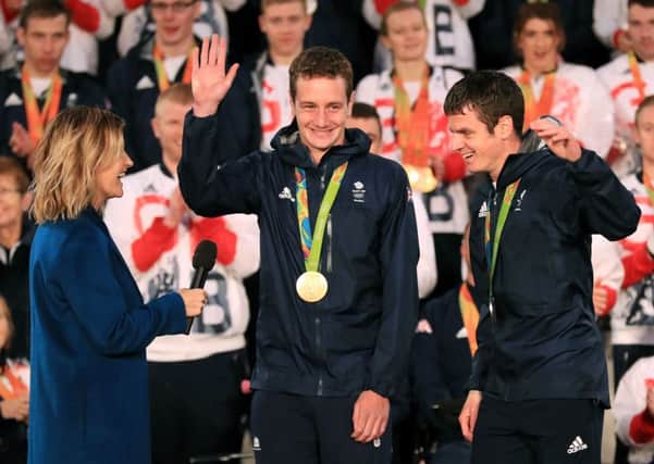 Alistair and Jonny Brownleee (right) are interviewed by BBC presenter Helen Skelton on stage during the Olympic and Paralympic athletes celebration parade in Manchester. PIC: PA