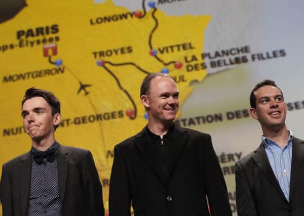 2016 Tour de France winner Chris Froome of Britain, centre, Australia's Richie Porte, right, and France's Romain Bardet poses during the presentation of the 2017 Tour de France cycling race in Paris, France. (AP Photo/Christophe Ena)