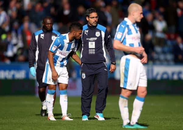 Huddersfield Town manager David Wagner consoles his players after defeat to Sheffield Wednesday on Sunday. Picture: Danny Lawson/PA.