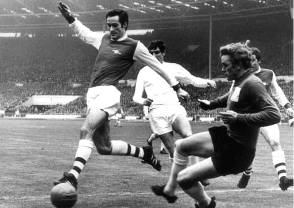 George Graham playing for Arsenal against Leeds  is marked by Norman Hunter as he approaches Gary Sprake in the 1968 League Cup Final at Wembley